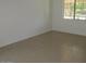 Simple bedroom with tile flooring and window at 43624 W Bailey Dr, Maricopa, AZ 85138