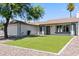 Single story home with a two car garage and landscaped front yard at 6802 E Beverly Ln, Scottsdale, AZ 85254