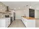 Modern kitchen with white cabinets, butcher block island, and patterned tile backsplash at 6802 E Beverly Ln, Scottsdale, AZ 85254