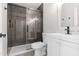 Modern bathroom with white vanity, glass shower, and dark gray tile at 6802 E Beverly Ln, Scottsdale, AZ 85254