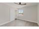 Spacious bedroom with ceiling fan, large window, and wood-look floors at 6802 E Beverly Ln, Scottsdale, AZ 85254