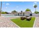 Artificial turf backyard with seating area and rock landscaping at 6802 E Beverly Ln, Scottsdale, AZ 85254