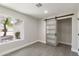 Bedroom with large window, closet, and barn door at 6802 E Beverly Ln, Scottsdale, AZ 85254