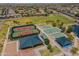 Aerial view of community amenities including tennis and basketball courts, playground, and ramadas at 18465 N Falcon Ln, Maricopa, AZ 85138