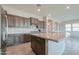 Modern kitchen with dark wood cabinets and granite island at 18465 N Falcon Ln, Maricopa, AZ 85138