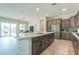 Modern kitchen with granite countertops and island at 18465 N Falcon Ln, Maricopa, AZ 85138