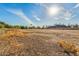 Vacant land with dry grass and distant homes at 1112 N Center St, Mesa, AZ 85201
