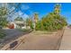 Small light green house with a yard and gravel driveway at 1112 N Center St, Mesa, AZ 85201