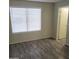 Spacious bedroom with wood-look floors and a large window at 5236 W Peoria Ave # 135, Glendale, AZ 85302