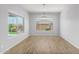 Empty dining room with hardwood floors and large windows at 26496 W Lone Cactus Dr, Buckeye, AZ 85396