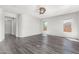 Spacious living room with hardwood floors and views to hallway at 26496 W Lone Cactus Dr, Buckeye, AZ 85396
