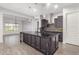 Modern kitchen with dark cabinetry, granite countertops, and island at 26496 W Lone Cactus Dr, Buckeye, AZ 85396