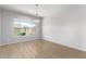 Simple dining room with hardwood floors and a chandelier at 26496 W Lone Cactus Dr, Buckeye, AZ 85396