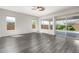 Living room with hardwood floors and sliding glass doors at 26496 W Lone Cactus Dr, Buckeye, AZ 85396