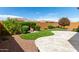 Landscaped backyard with artificial turf and a patio at 26496 W Lone Cactus Dr, Buckeye, AZ 85396