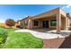 Backyard patio with artificial turf and a covered patio at 26496 W Lone Cactus Dr, Buckeye, AZ 85396