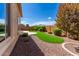 Landscaped backyard with artificial turf and stone at 26496 W Lone Cactus Dr, Buckeye, AZ 85396