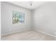 Bright bedroom with neutral walls, carpet flooring, and a window at 26496 W Lone Cactus Dr, Buckeye, AZ 85396