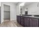 Elegant bathroom with double vanity and dark brown cabinets at 26496 W Lone Cactus Dr, Buckeye, AZ 85396