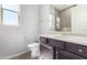 Modern bathroom with dark vanity and a walk-in shower at 26496 W Lone Cactus Dr, Buckeye, AZ 85396