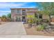 Two-story house with three-car garage and stone accents at 9231 W Bent Tree Dr, Peoria, AZ 85383