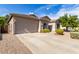 Tan one story home with a landscaped yard and driveway at 43502 W Kramer Ln, Maricopa, AZ 85138