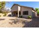 Backyard view of home with covered patio and gravel at 43502 W Kramer Ln, Maricopa, AZ 85138