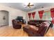 Living room with hardwood floors, sectional sofa and recliner at 43502 W Kramer Ln, Maricopa, AZ 85138