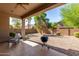 Covered patio and spacious backyard with gravel at 43502 W Kramer Ln, Maricopa, AZ 85138