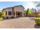 Backyard view of home with covered patio and gravel at 43502 W Kramer Ln, Maricopa, AZ 85138