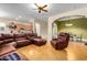 Open living room with hardwood floors and sectional sofa at 43502 W Kramer Ln, Maricopa, AZ 85138