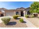 Tan one-story home with a landscaped yard and walkway at 43502 W Kramer Ln, Maricopa, AZ 85138
