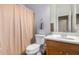 Clean bathroom with a shower/tub combo and wood vanity at 43502 W Kramer Ln, Maricopa, AZ 85138