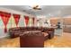Large living room with hardwood floors, sectional sofa and kitchen view at 43502 W Kramer Ln, Maricopa, AZ 85138