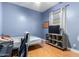 Bedroom with wood floors, ceiling fan, and built-in shelving at 43502 W Kramer Ln, Maricopa, AZ 85138