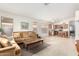 Open living room with a neutral color palette, comfortable seating, and views into the kitchen at 2420 W Blue Sky Dr, Phoenix, AZ 85085