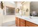 Bathroom with double vanity, large mirror and a bathtub at 2420 W Blue Sky Dr, Phoenix, AZ 85085