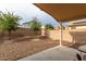 Small backyard with gravel and covered patio area at 2420 W Blue Sky Dr, Phoenix, AZ 85085