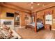 Spacious main bedroom with a four-poster bed and fireplace at 8157 E Sierra Morena St, Mesa, AZ 85207