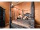 Bedroom with a four-poster bed and ornate headboard at 8157 E Sierra Morena St, Mesa, AZ 85207