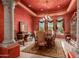 Formal dining room with ornate chandelier and red walls at 8157 E Sierra Morena St, Mesa, AZ 85207