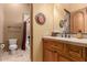 Small bathroom with toilet, shower/tub combo, and wood vanity at 8157 E Sierra Morena St, Mesa, AZ 85207