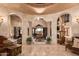 Spacious living room with fountain, high ceilings, and arched openings at 8157 E Sierra Morena St, Mesa, AZ 85207