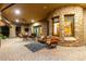 Spacious outdoor patio with comfortable seating and a stone accent wall at 8157 E Sierra Morena St, Mesa, AZ 85207
