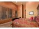 Bedroom with a dark wood bed frame and red bedding, offering a cozy atmosphere at 8157 E Sierra Morena St, Mesa, AZ 85207