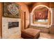 Luxurious bathroom with a soaking tub and fireplace at 8157 E Sierra Morena St, Mesa, AZ 85207