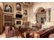 Living room with a fireplace, large windows and leather furniture at 8157 E Sierra Morena St, Mesa, AZ 85207