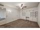 Bedroom with ceiling fan, built-in shelves, and carpet at 13447 W Copperstone Dr, Sun City West, AZ 85375