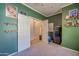 Bright bedroom with green walls and plenty of storage at 14293 W Fairmount Ave, Goodyear, AZ 85395