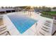 Community pool with lounge chairs and play area at 9987 W Verde Ln, Avondale, AZ 85392